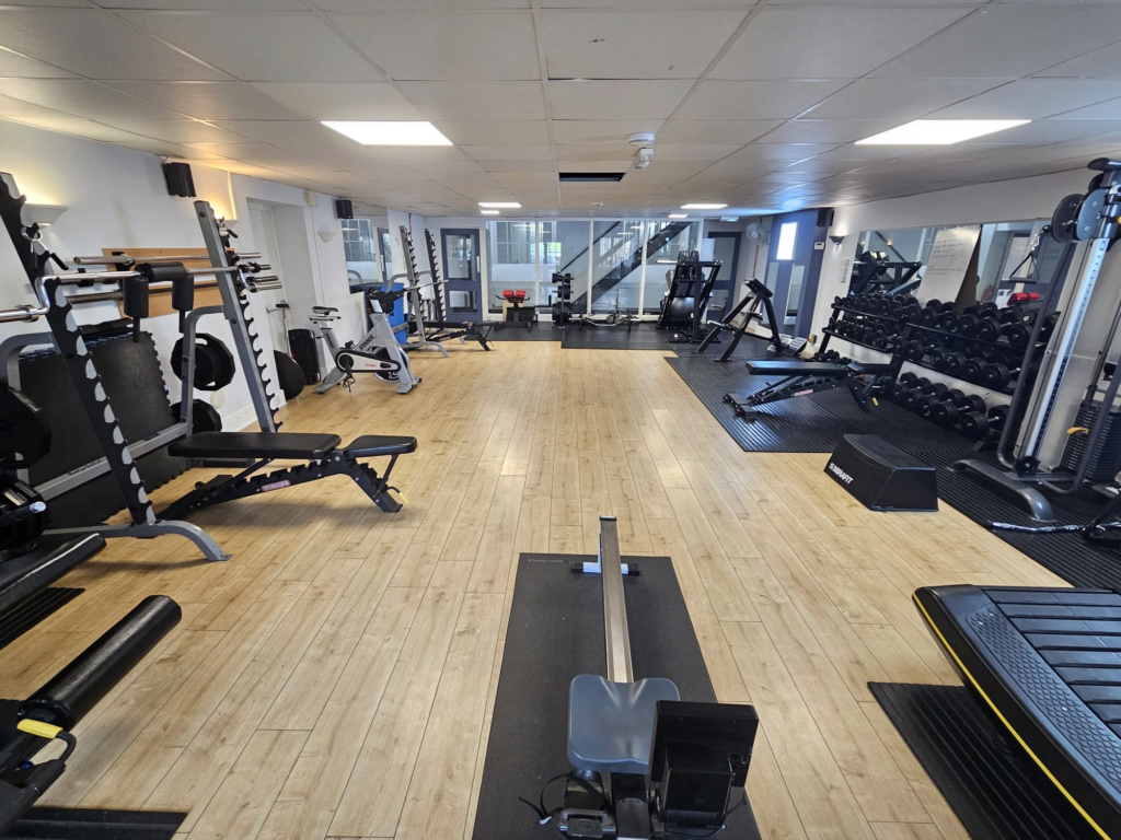 a gym room with a variety of exercise equipment